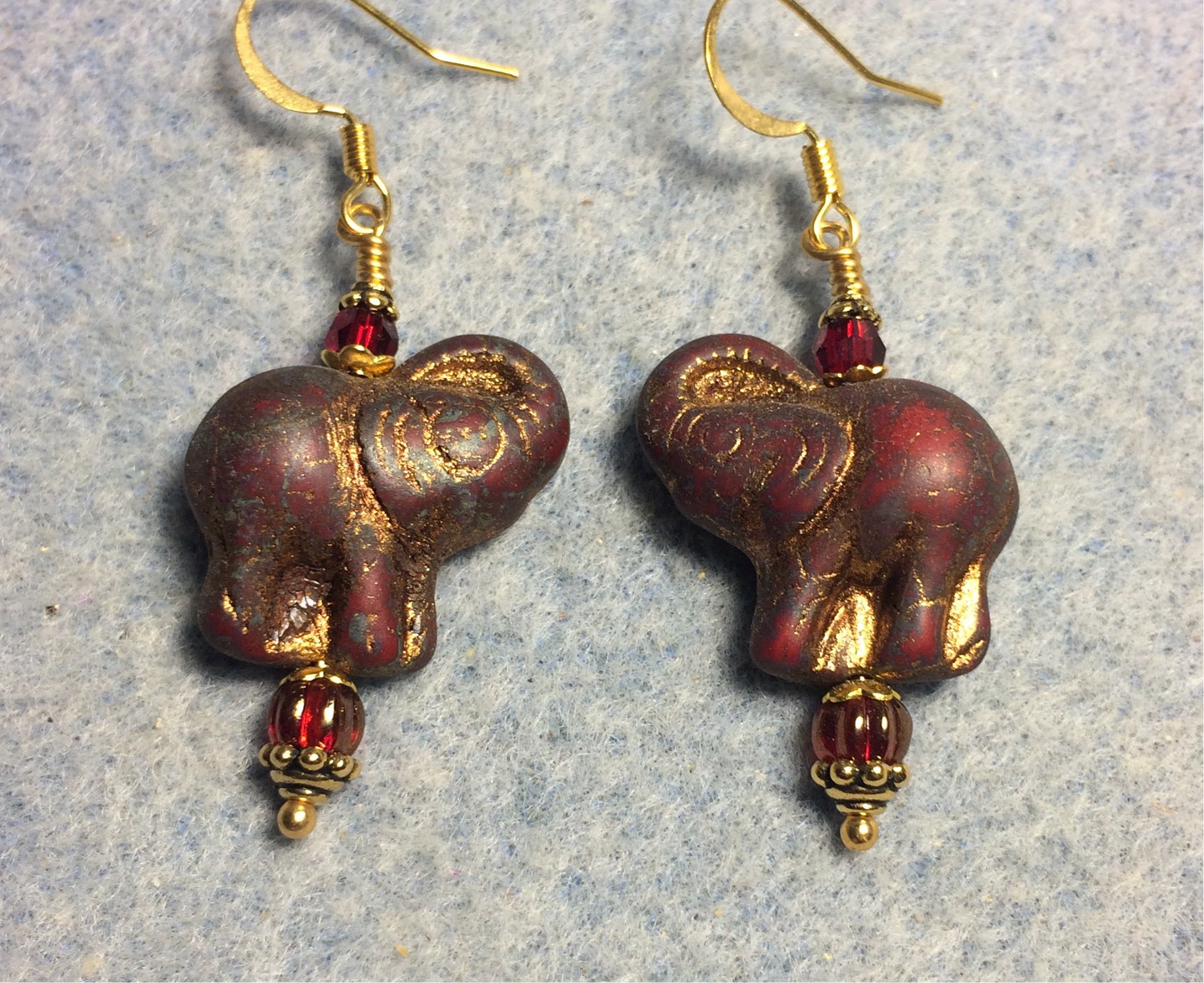 Opaque dark red (with gold inlay) Czech glass elephant bead earrings adorned with dark red Czech glass beads.