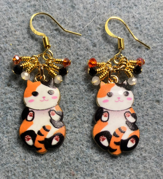 Orange, black, and white enamel calico cat charm earrings adorned with tiny dangling orange, black, and white Chinese crystal beads.