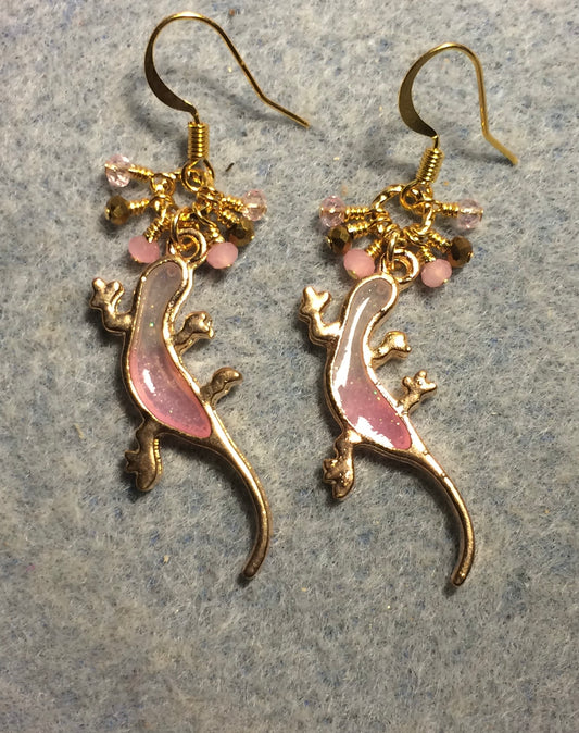 Pink and gold resin lizard charm earrings adorned with tiny dangling pink and gold Chinese crystal beads.