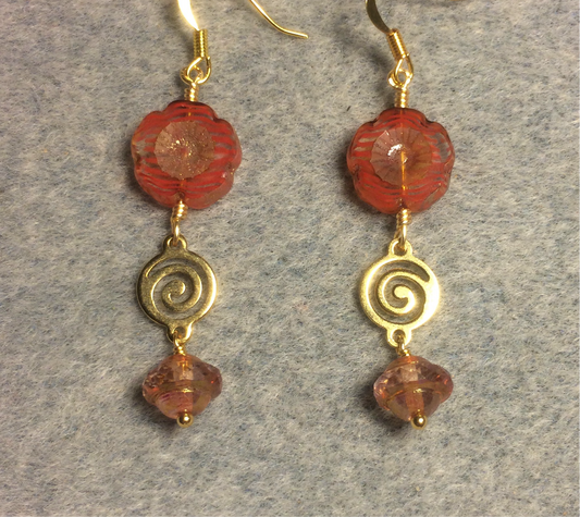 Tangerine Czech glass pansy bead earrings adorned with gold swirly connectors and tangerine and gold Czech glass Saturn beads.