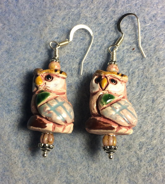 Pink and yellow ceramic owl bead earrings adorned with light pink Czech glass beads.