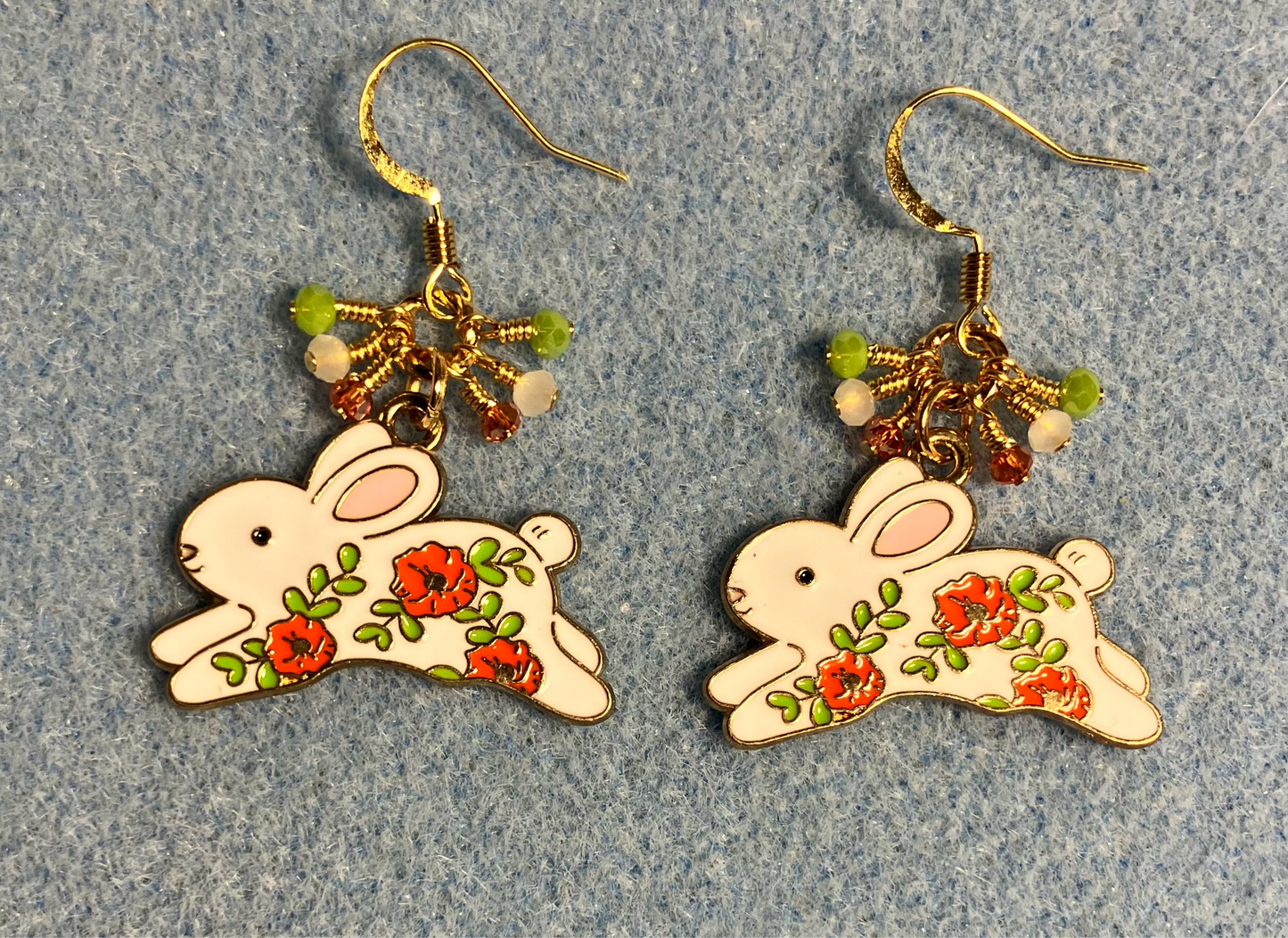 White, orange, and olive green enamel rabbit charm earrings adorned with white, orange, and olive green Chinese crystal beads.