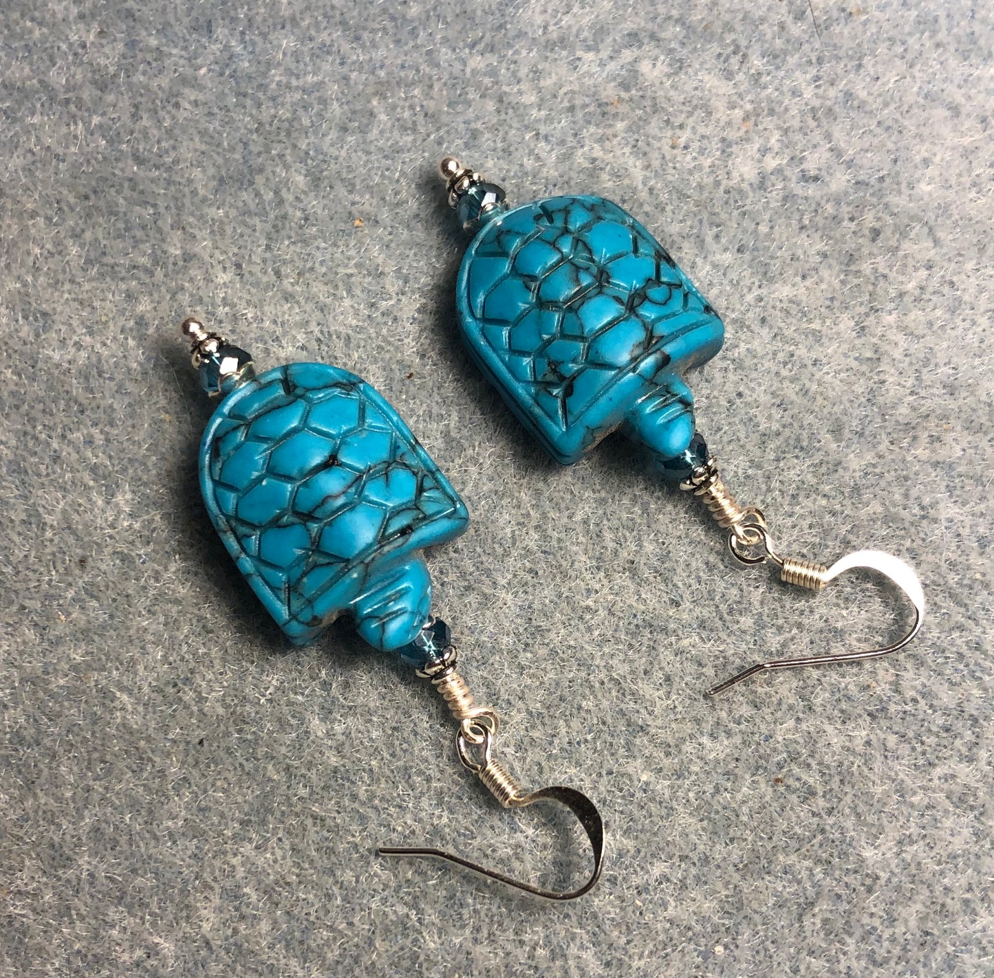 Turquoise howlite gemstone turtle bead earrings adorned with turquoise Chinese crystal beads.