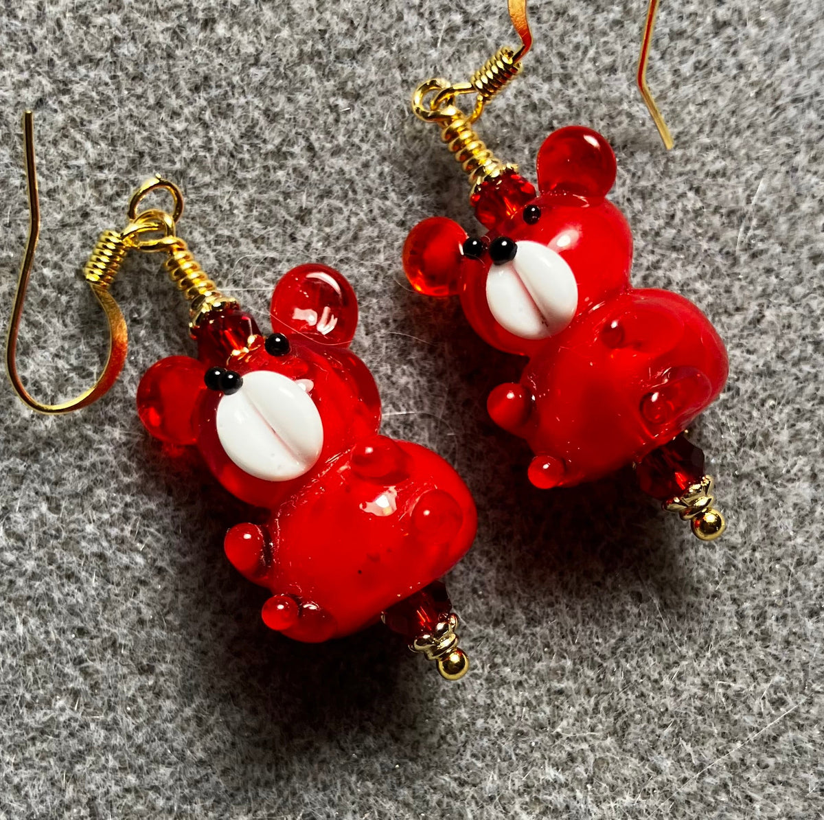 Bright red and white lamp work teddy bear bead earrings adorned with bright red Chinese crystal beads.