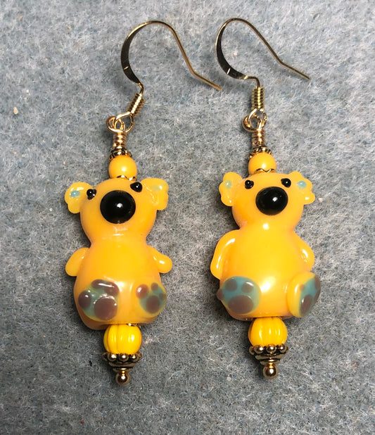 Large golden yellow lamp work koala bear bead earrings adorned with golden yellow Czech glass beads.