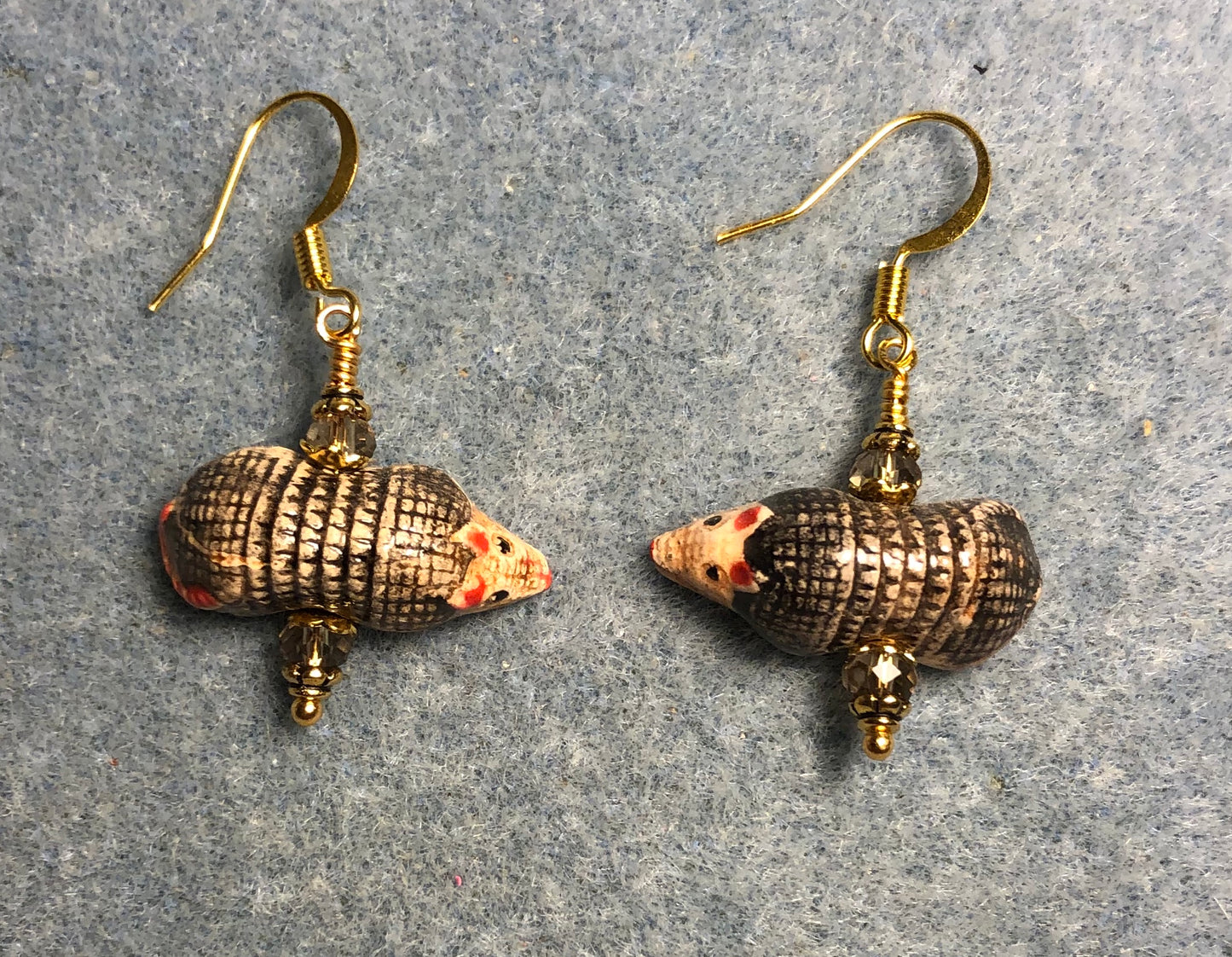 Small brown and gray ceramic armadillo bead earrings adorned with gray Chinese crystal beads.