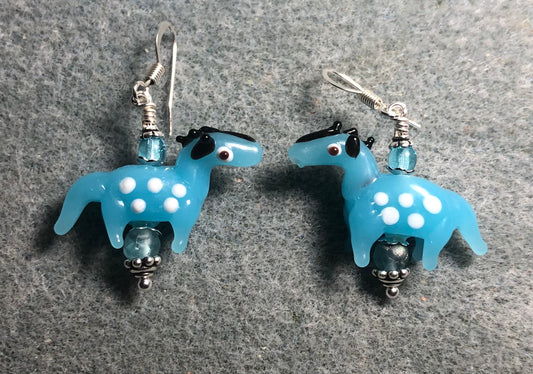 Light turquoise lamp work spotted horse bead earrings adorned with turquoise Czech glass beads.