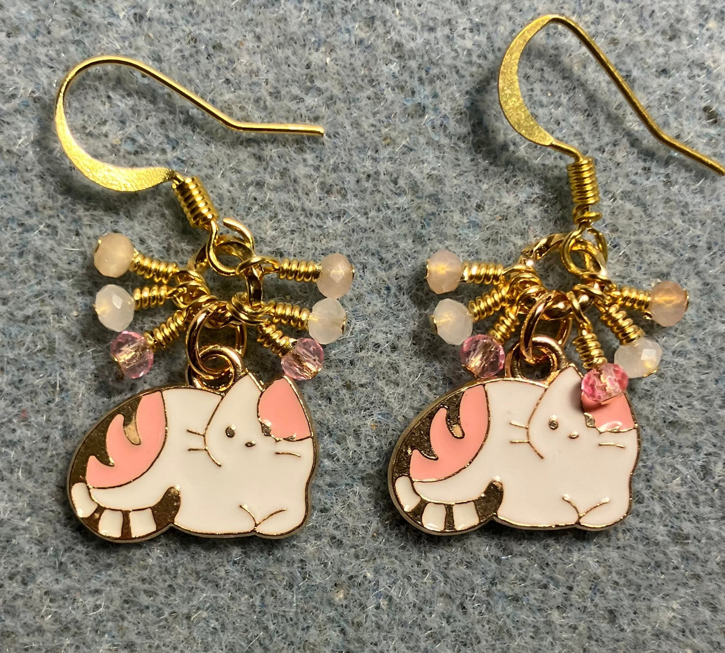 Small pink and white enamel cat charm earrings adorned with tiny dangling pink and white Chinese crystal beads.