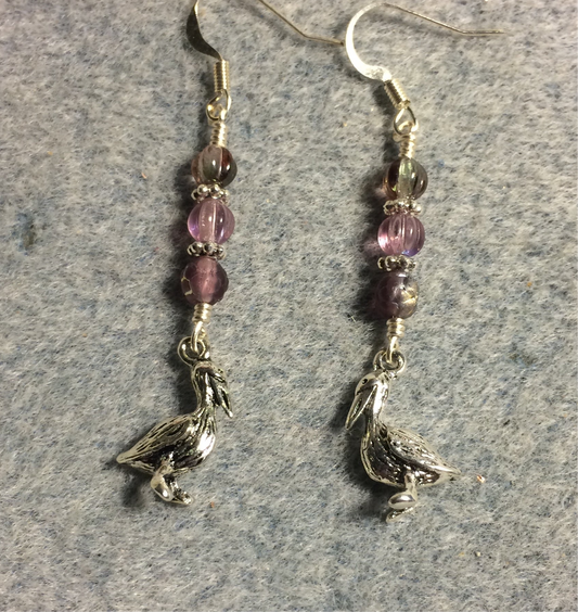 Small silver pelican charm earrings adorned with small violet Czech glass beads