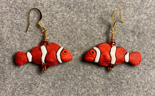 Red, black, and white ceramic striped clownfish bead earrings adorned with red Chinese crystal beads.