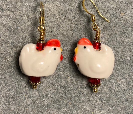 White and red ceramic chicken bead earrings adorned with red Czech glass beads.