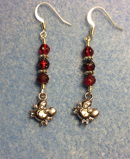 Small silver crab charm earrings adorned with small dark red Czech glass beads