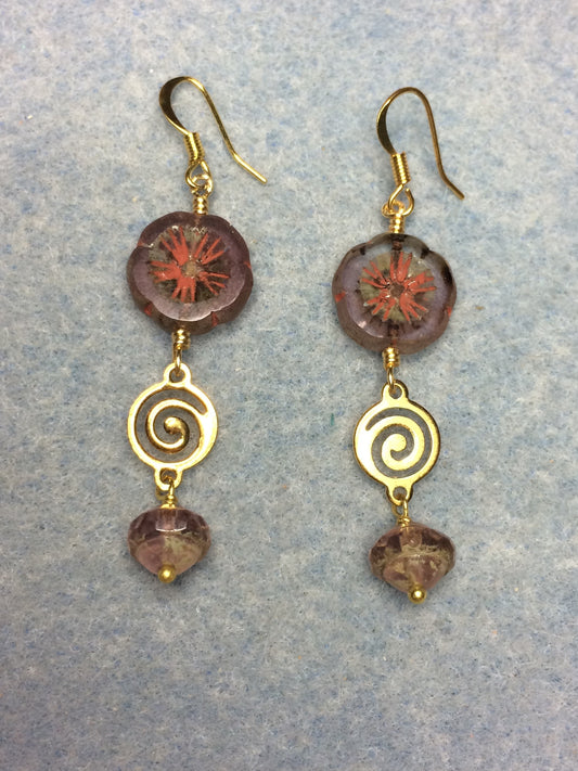 Translucent violet Czech glass pansy bead earrings adorned with gold swirly connectors and violet Czech glass Saturn beads.