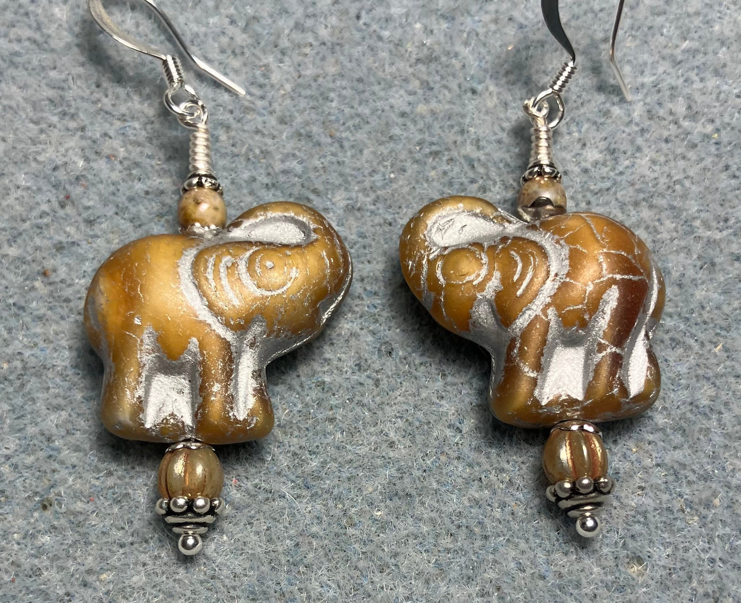 Beige (with silver inlay) Czech glass elephant bead earrings adorned with beige Czech glass beads.
