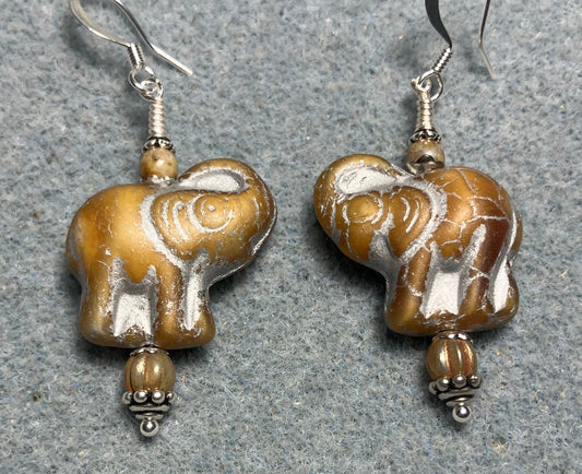 Beige (with silver inlay) Czech glass elephant bead earrings adorned with beige Czech glass beads.