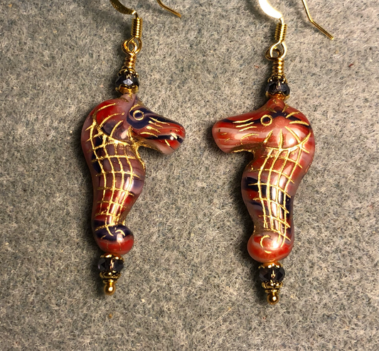 Reddish orange and purple (with gold inlay) Czech glass seahorse bead earrings adorned with purple Chinese crystal beads.