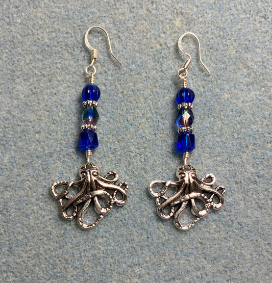 Silver octopus charm earrings adorned with dark blue Czech glass beads.