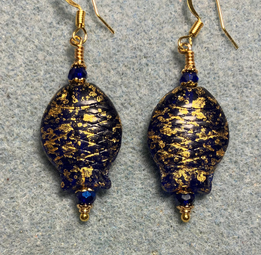 Dark blue and gold Czech glass fish bead earrings adorned with dark blue Chinese crystal beads.