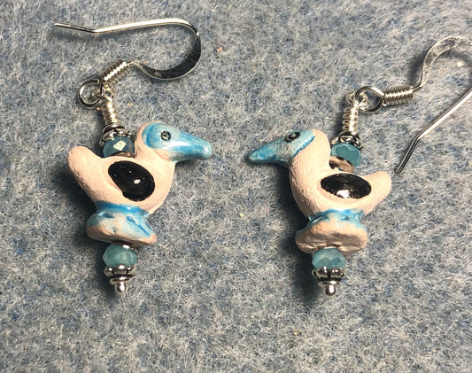 Small tan, turquoise, and black ceramic seagull bead earrings adorned with small turquoise Chinese crystal beads.