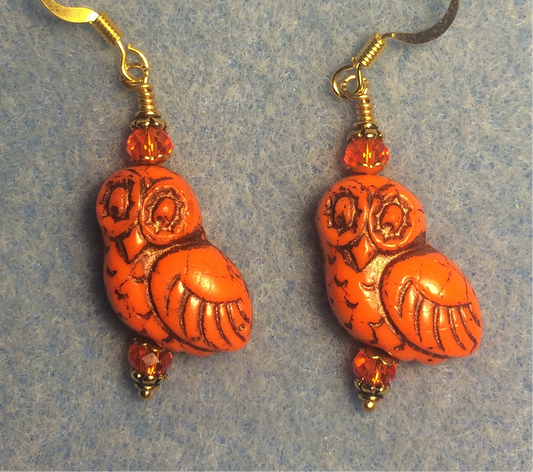 Orange (with black wash) fancy Czech glass owl bead earrings adorned with orange Chinese crystal beads.