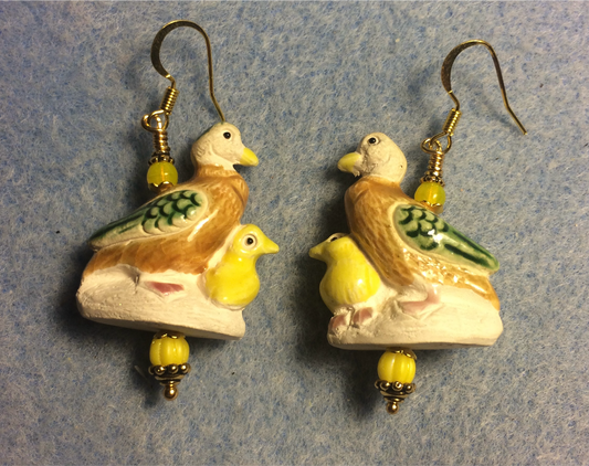 Brown, green, and yellow ceramic mother and baby duck bead earrings adorned with yellow Czech glass beads.