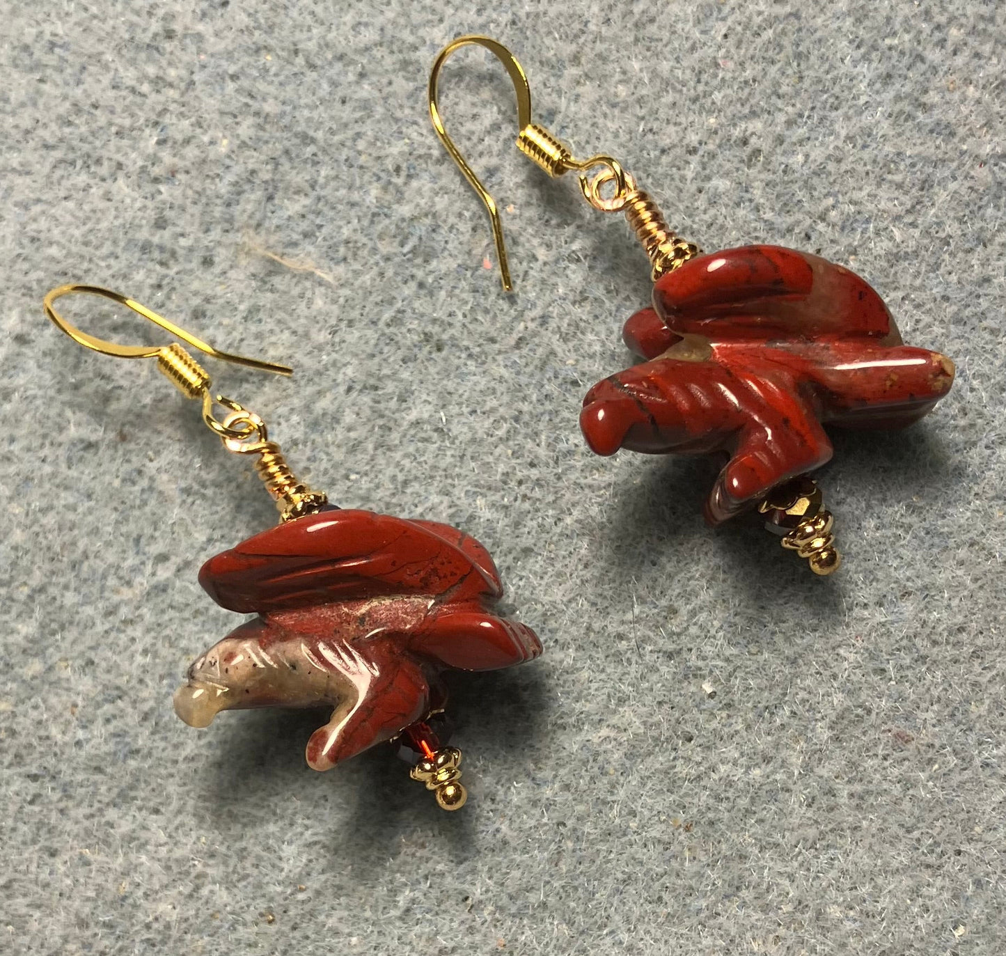 Large red poppy jasper gemstone flying eagle bead earrings adorned with dark red Chinese crystal beads.