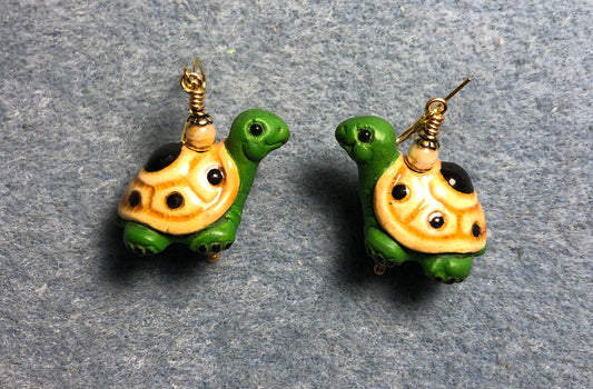 Green and tan ceramic turtle bead earrings adorned with tan Czech glass beads.