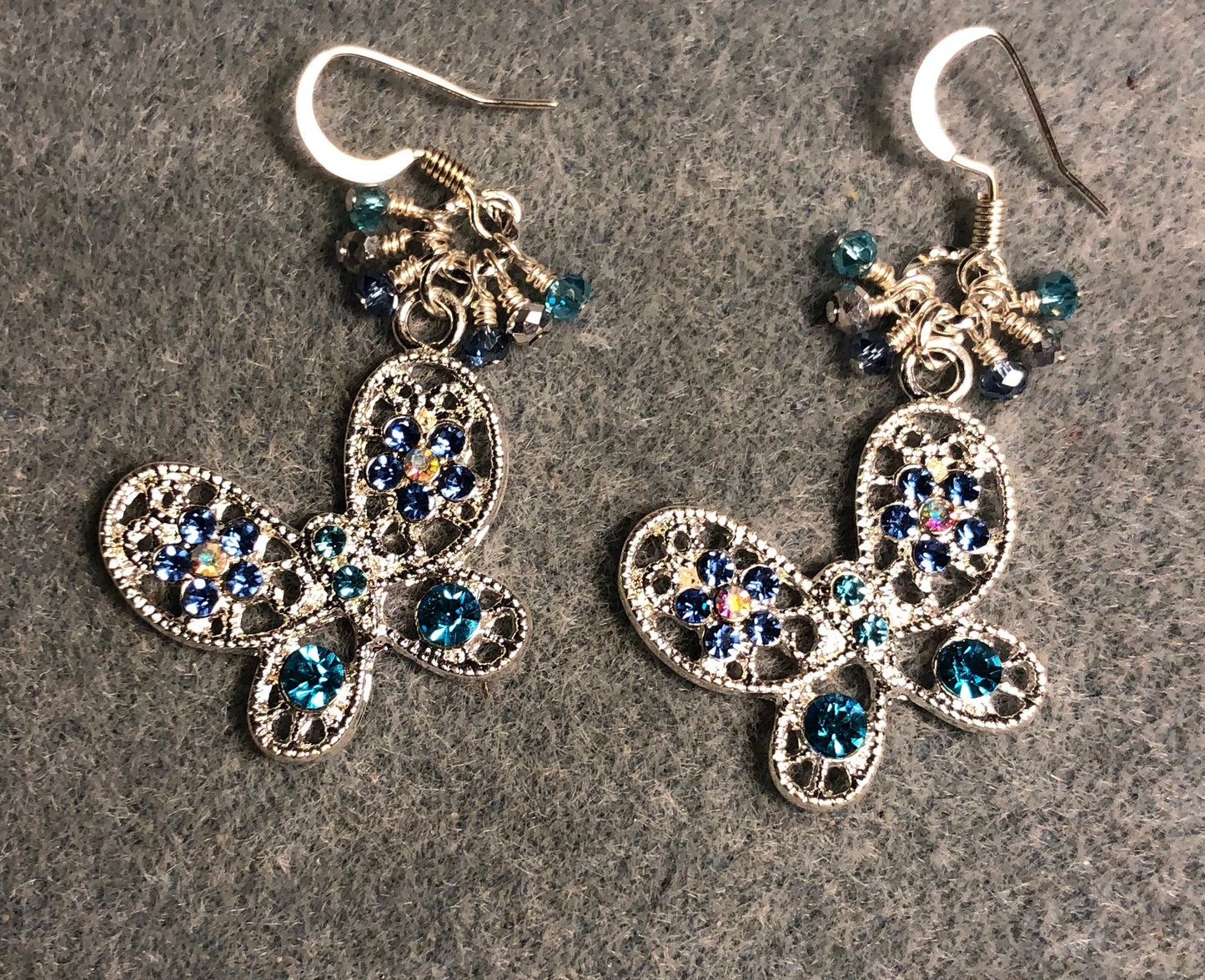 Silver, turquoise, and blue rhinestone butterfly charm earrings adorned with tiny dangling turquoise, silver, and blue Chinese crystal beads.