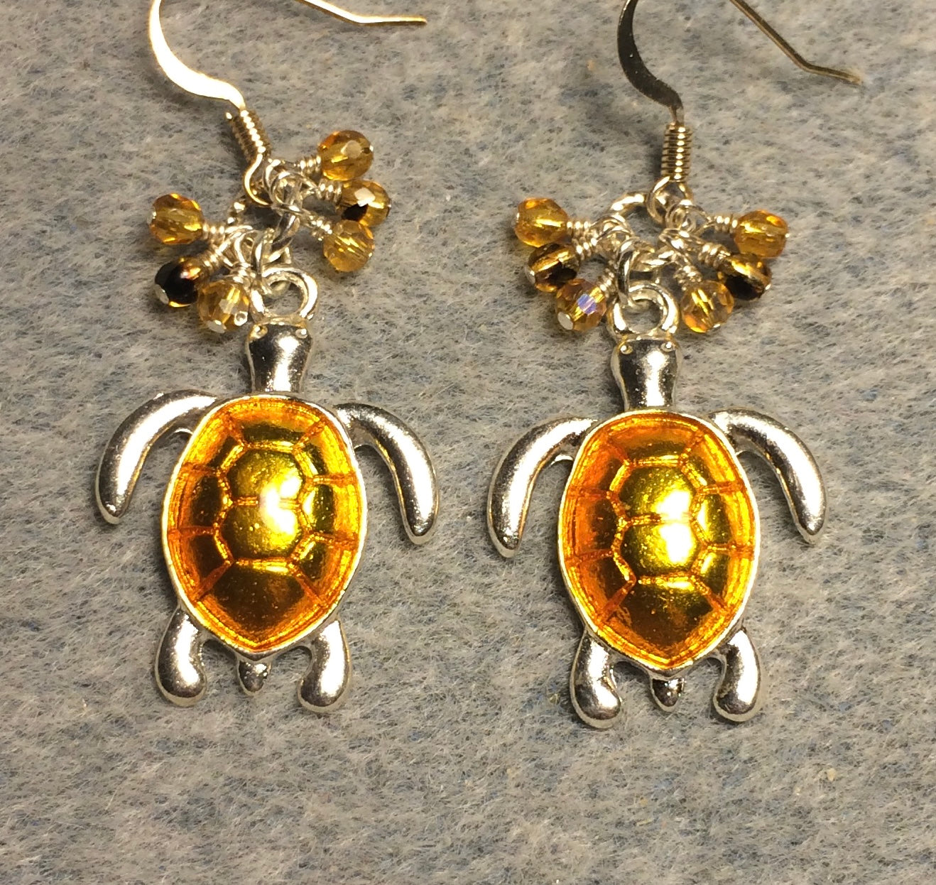 Silver and bright topaz enamel sea turtle charm earrings adorned with small dangling topaz and amber Czech glass beads.