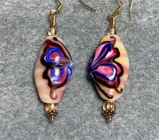 Purple and tan lamp work butterfly bead earrings adorned with tan Czech glass beads.