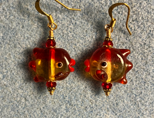 Red and amber lamp work fish bead earrings adorned with red Chinese crystal beads.