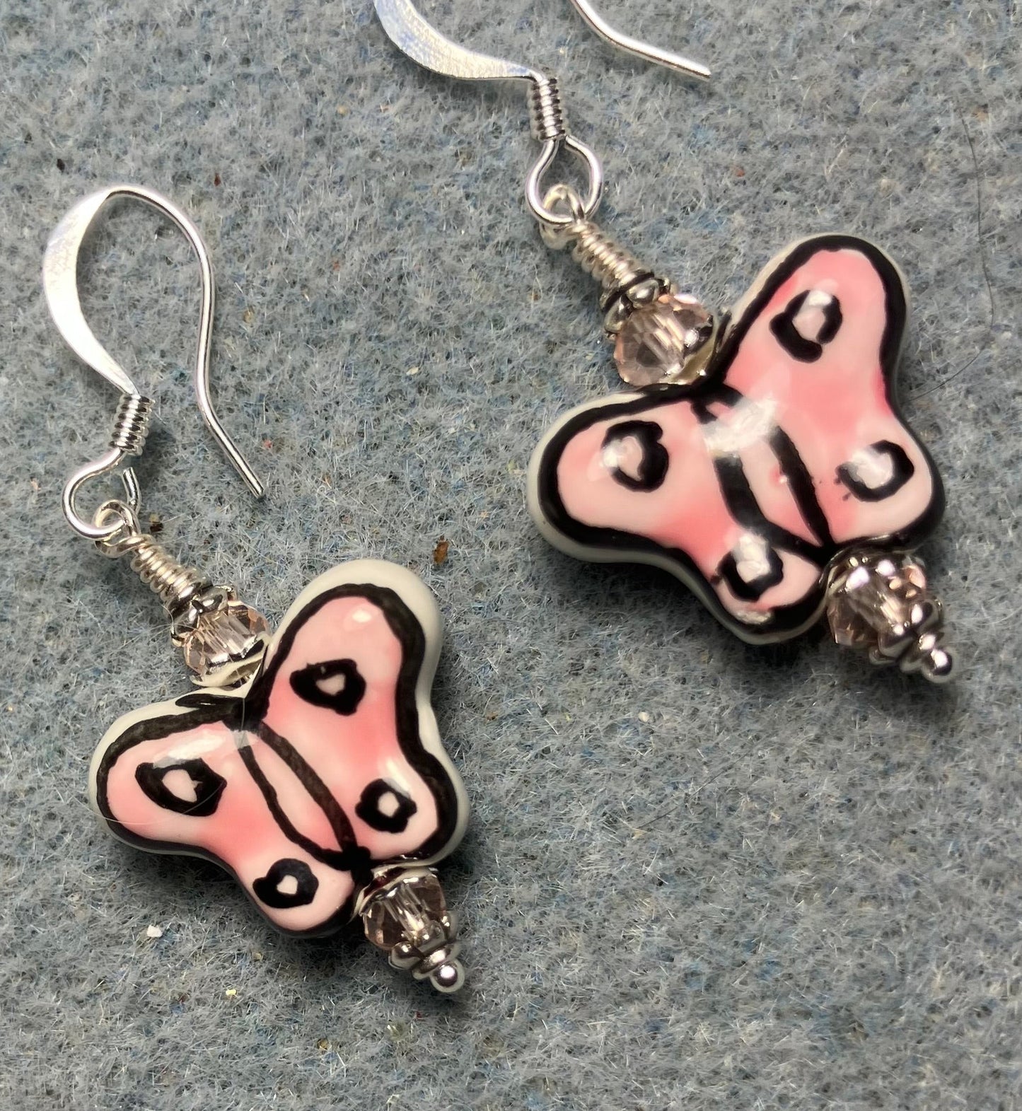 Pink and black ceramic butterfly bead earrings adorned with pink Chinese crystal beads.