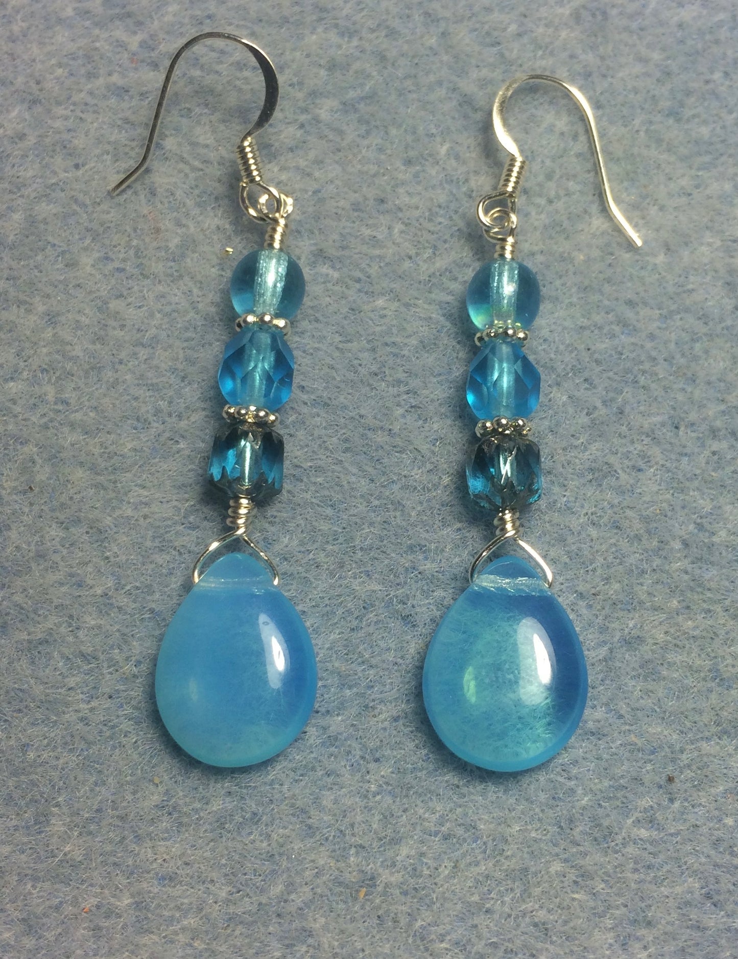 Turquoise Czech glass pear drop bead earrings adorned with turquoise Czech glass beads.