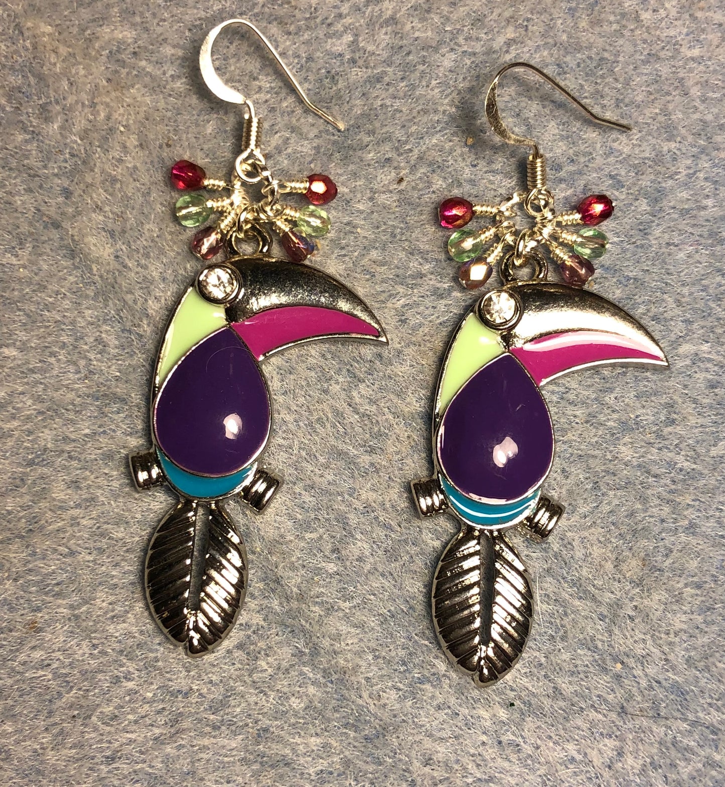 Vintage purple, pink, and light green enamel toucan charm earrings adorned with tiny dangling purple, pink, and light green Czech glass beads.
