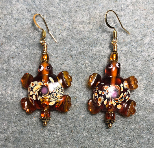 Large spotted caramel lamp work turtle bead earrings adorned with caramel Czech glass beads.