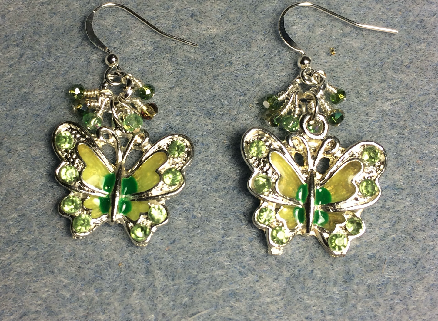 Silver and green enamel and rhinestone butterfly charm earrings adorned with tiny dangling olive green and light green Chinese crystal beads.