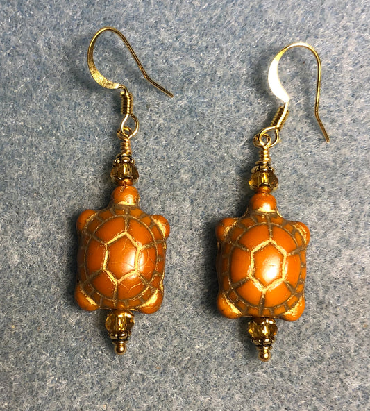 Opaque topaz Czech glass turtle bead earrings adorned with topaz Chinese crystal beads.