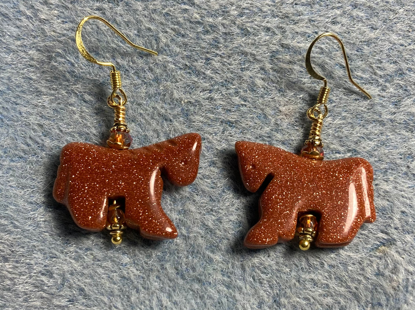 Orange goldstone gemstone horse bead earrings adorned with orange Chinese crystal beads.
