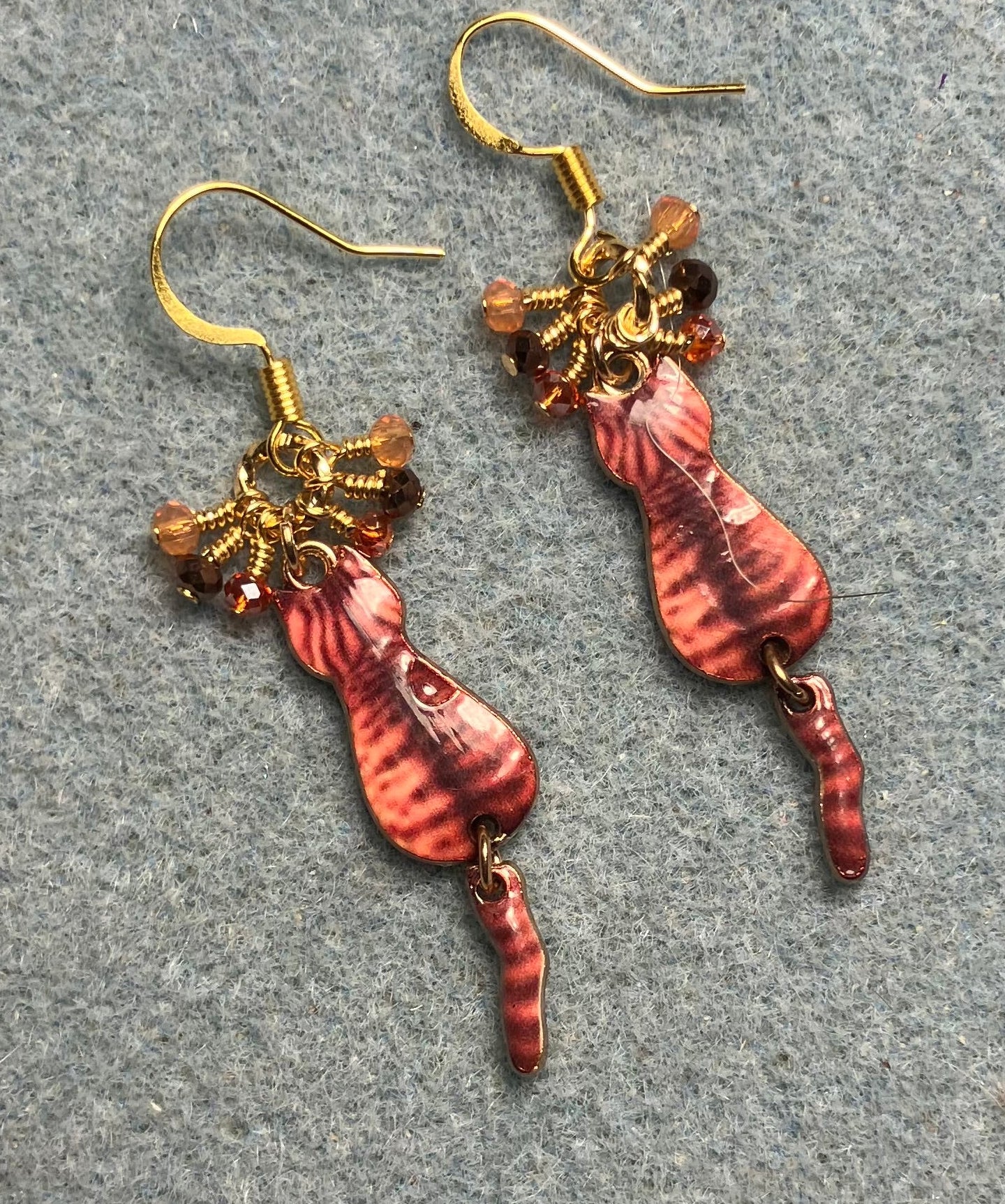 Orange and brown enamel tabby cat charm earrings adorned with tiny dangling orange and brown Chinese crystal beads.