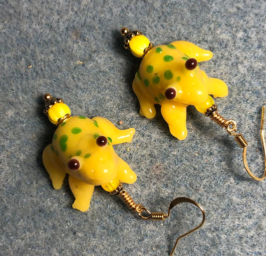 Yellow and green lamp work spotted frog bead earrings adorned with yellow Czech glass beads.