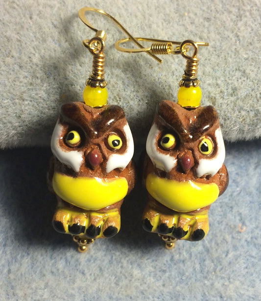 Large brown, yellow, and white ceramic owl bead earrings adorned with yellow Czech glass beads.