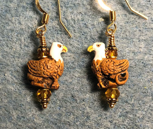 Small amber, white, and yellow ceramic griffin bead earrings adorned with amber Chinese crystal beads.