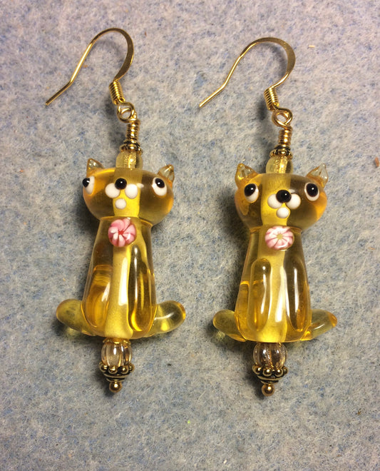 Translucent amber lamp work cat bead earrings adorned with amber Czech glass beads.