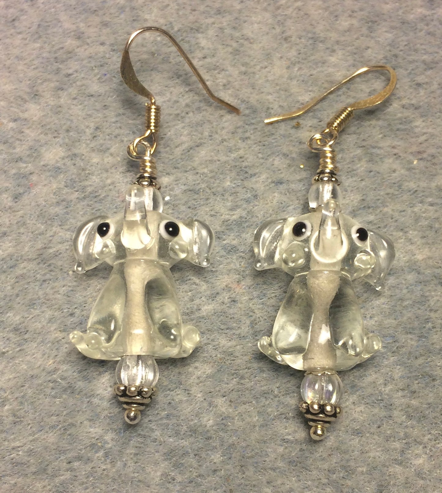 Translucent clear lamp work sitting elephant bead earrings adorned with clear Czech glass beads.