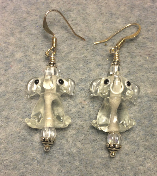 Translucent clear lamp work sitting elephant bead earrings adorned with clear Czech glass beads.