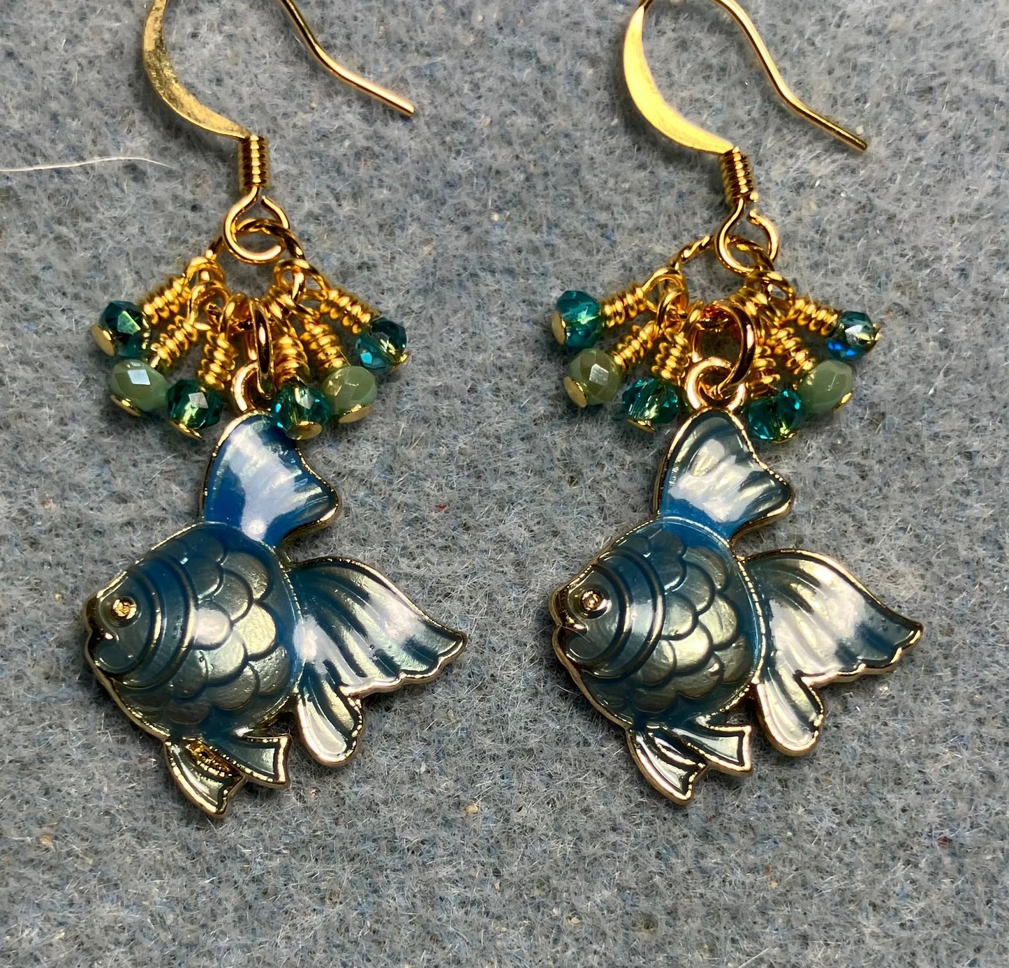 Metallic turquoise enamel angelfish charm earrings adorned with tiny dangling turquoise Chinese crystal beads.