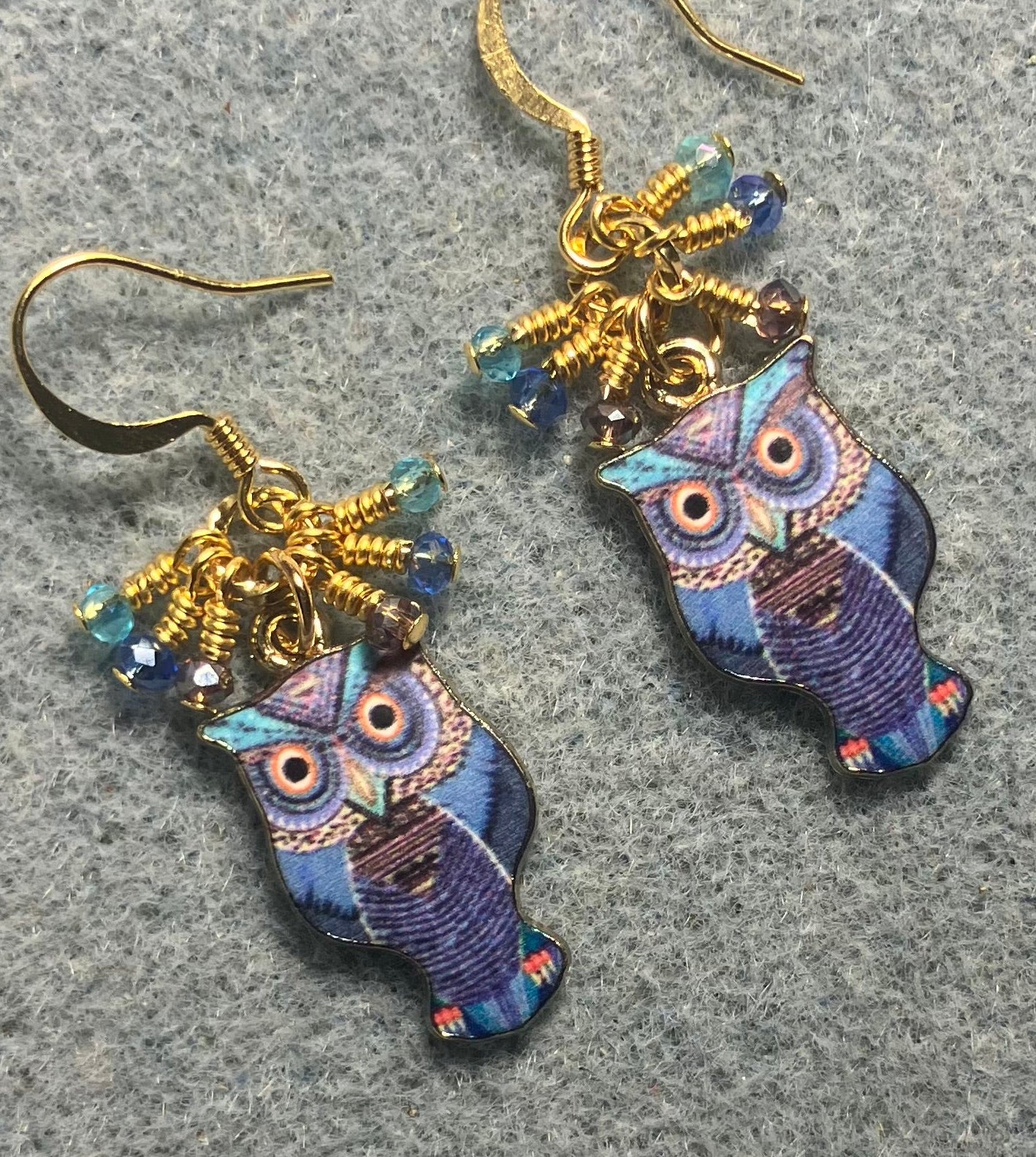 Dark blue, turquoise, and violet enamel owl charm earrings adorned with tiny dangling dark blue, turquoise, and violet Chinese crystal beads.