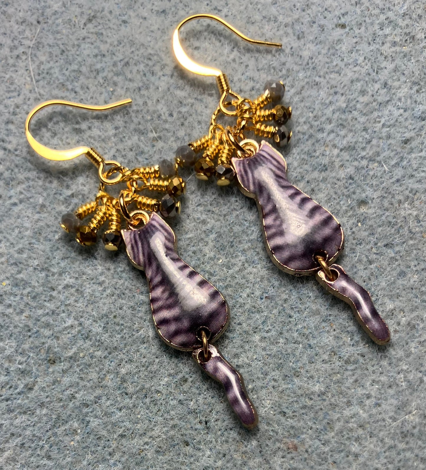 Gray and gold enamel tabby cat charm earrings adorned with tiny dangling gray and gold Chinese crystal beads.