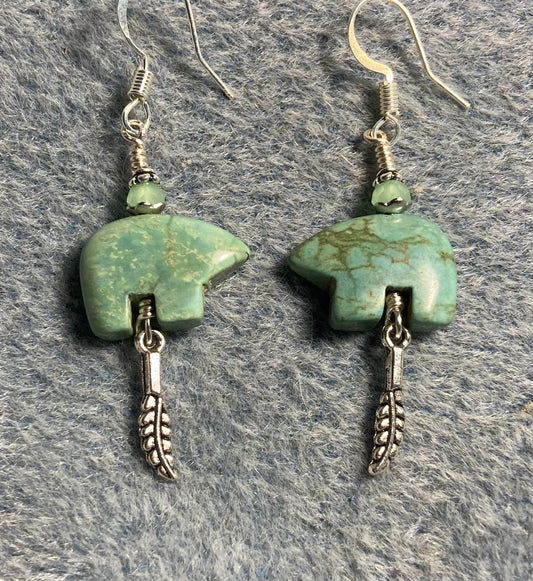 Green turquoise gemstone Zuni bear fetish bear earrings adorned with light green crystal beads and tiny silver feather charms.