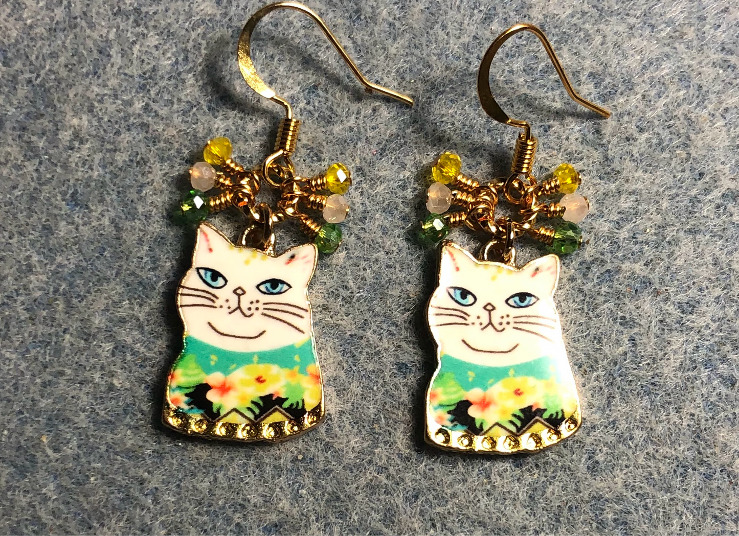 White, green, and yellow enamel cat charm earrings adorned with tiny dangling white, green, and yellow Chinese crystal beads.